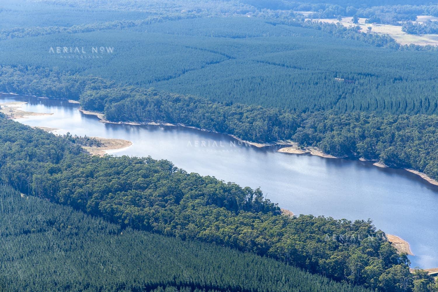 Aerial view of Bostock Reservoir at Bolwarrah, Victoria, showing a narrow forested inlet, reservoir shoreline and surrounding plantation forestry.