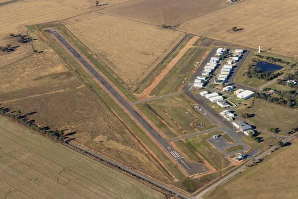 Aerial view of Yarrawonga Airport in Yarrawonga VIC, showing the runway, taxiways, hangars, apron areas and surrounding rural farmland.