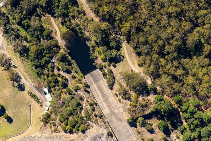 Aerial view of a West Barwon Reservoir inlet or offshoot surrounded by dense bushland and access tracks near Forrest, Victoria.