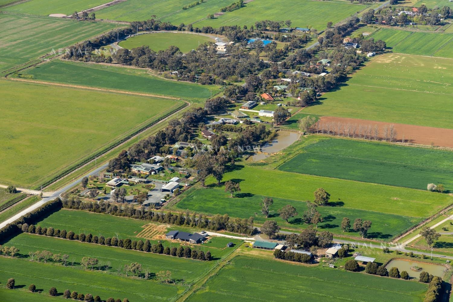 Aerial view of farmland and rural homes along Weller Road in Lancaster VIC, with green paddocks, tree lines and farm tracks.