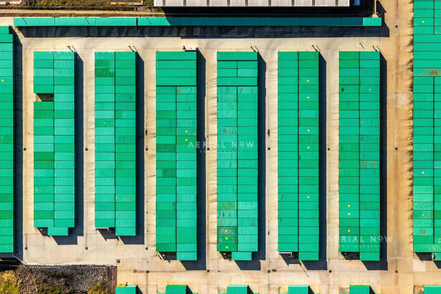 Aerial view of rows of green-roofed storage units and concrete driveways in Harristown, Toowoomba, Queensland.
