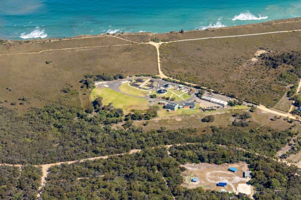 Aerial view of Anglesea Water Reclamation Plant with treatment ponds and utility buildings set among coastal vegetation near the Bass Strait shoreline in Anglesea, Victoria.