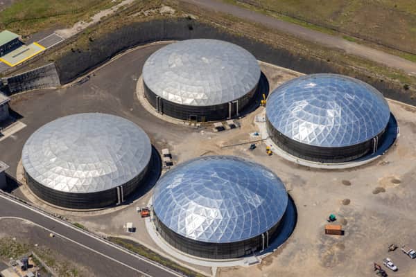 Aerial view of four large covered utility process tanks at an industrial infrastructure site in Craigieburn, with access roads, hardstand areas and service vehicles visible.